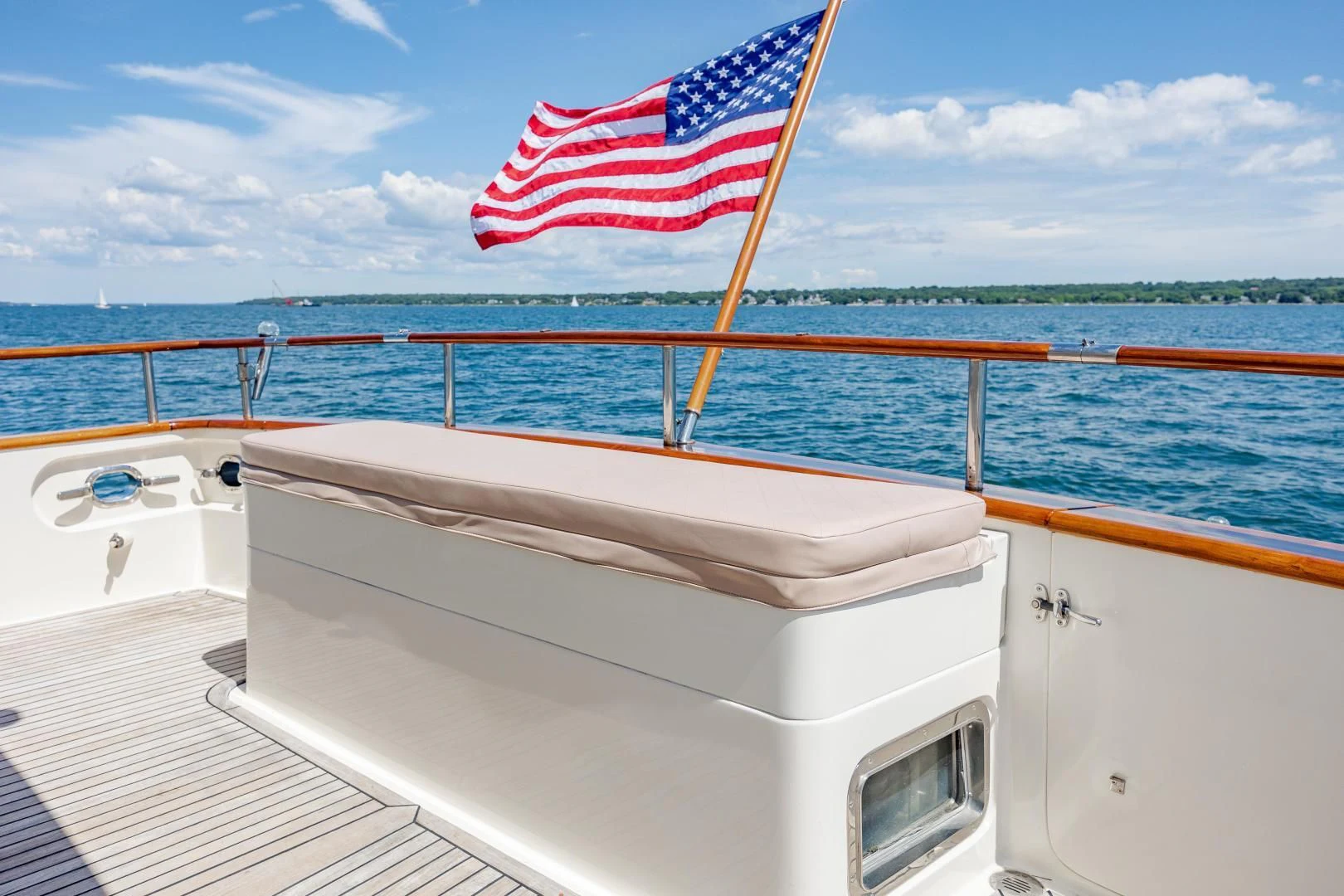 a boat with a flag on the front aboard DISCONNECTED Yacht for Sale