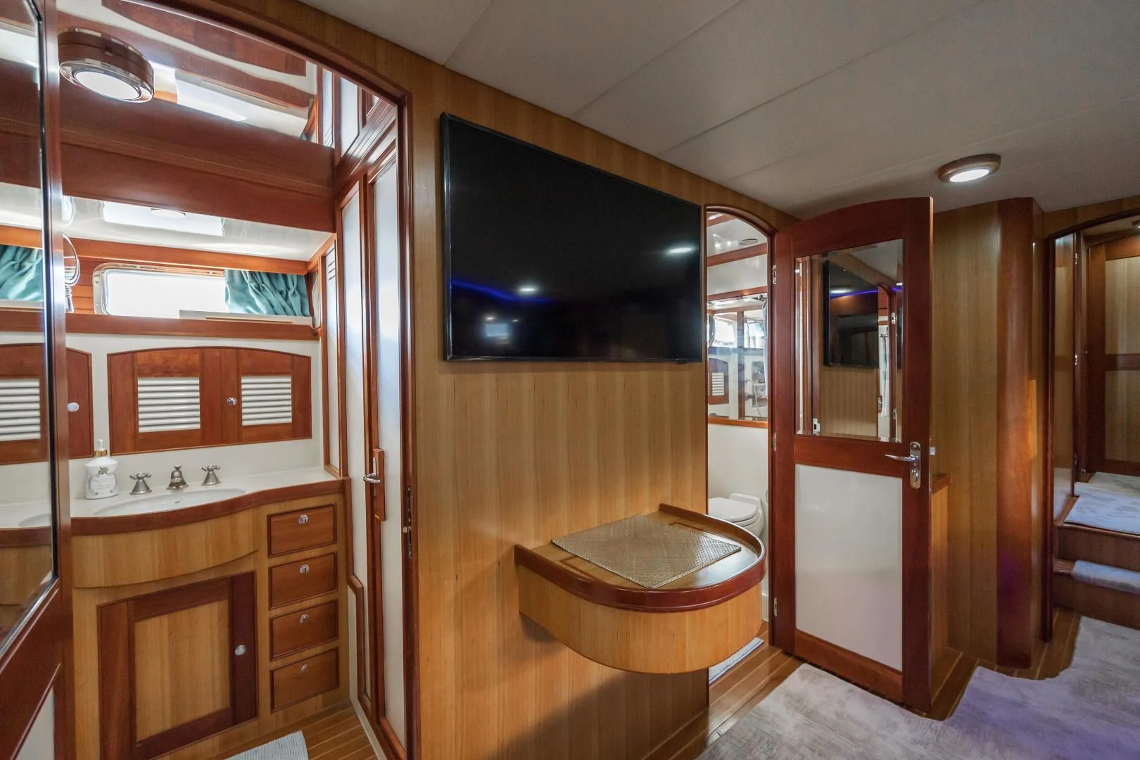 a room with a tv and a table aboard DISCONNECTED Yacht for Sale