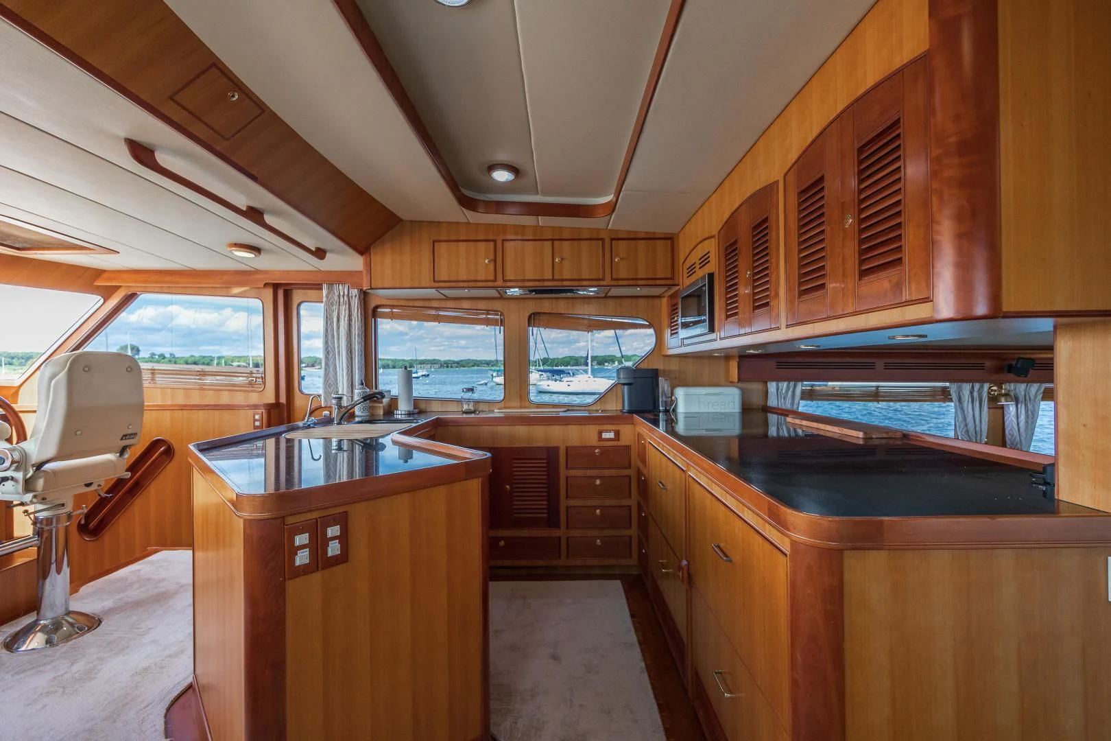 a kitchen with wooden cabinets aboard DISCONNECTED Yacht for Sale
