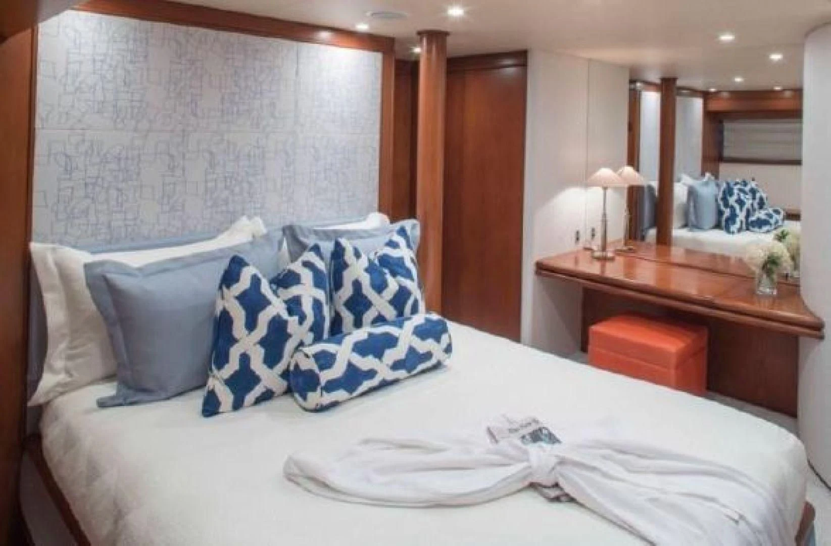 a bed with white sheets and pillows aboard AT LAST Yacht for Charter
