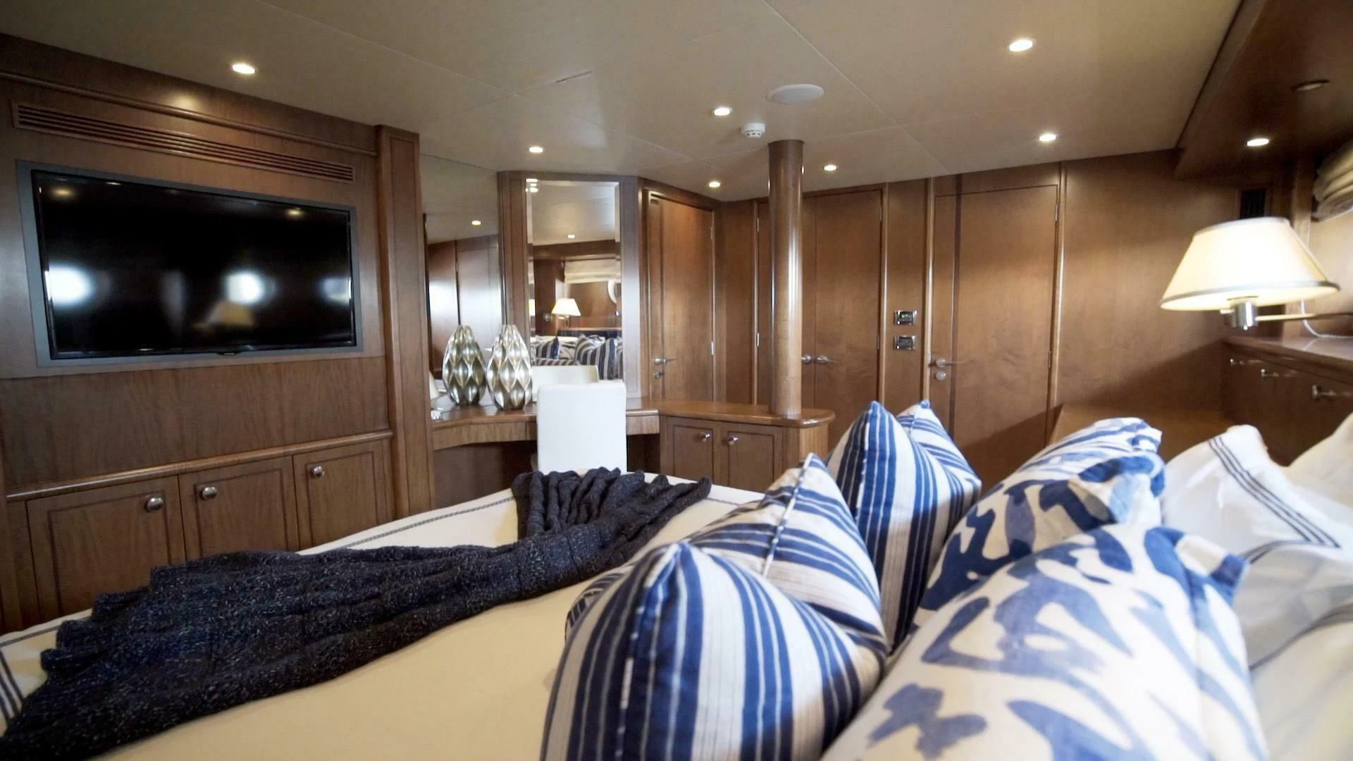 a room with a tv and a bed aboard AT LAST Yacht for Charter