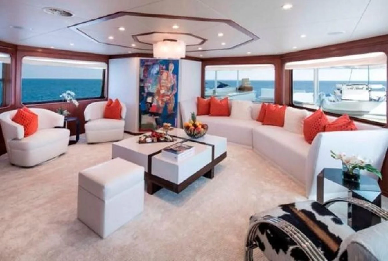 a living room with white couches aboard AT LAST Yacht for Charter