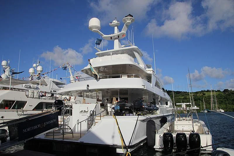 a large white boat docked aboard AT LAST Yacht for Charter