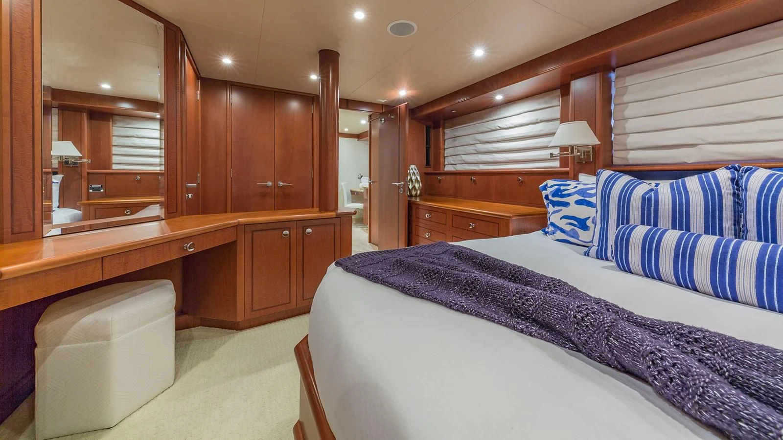 a bedroom with a bed and desk aboard AT LAST Yacht for Charter