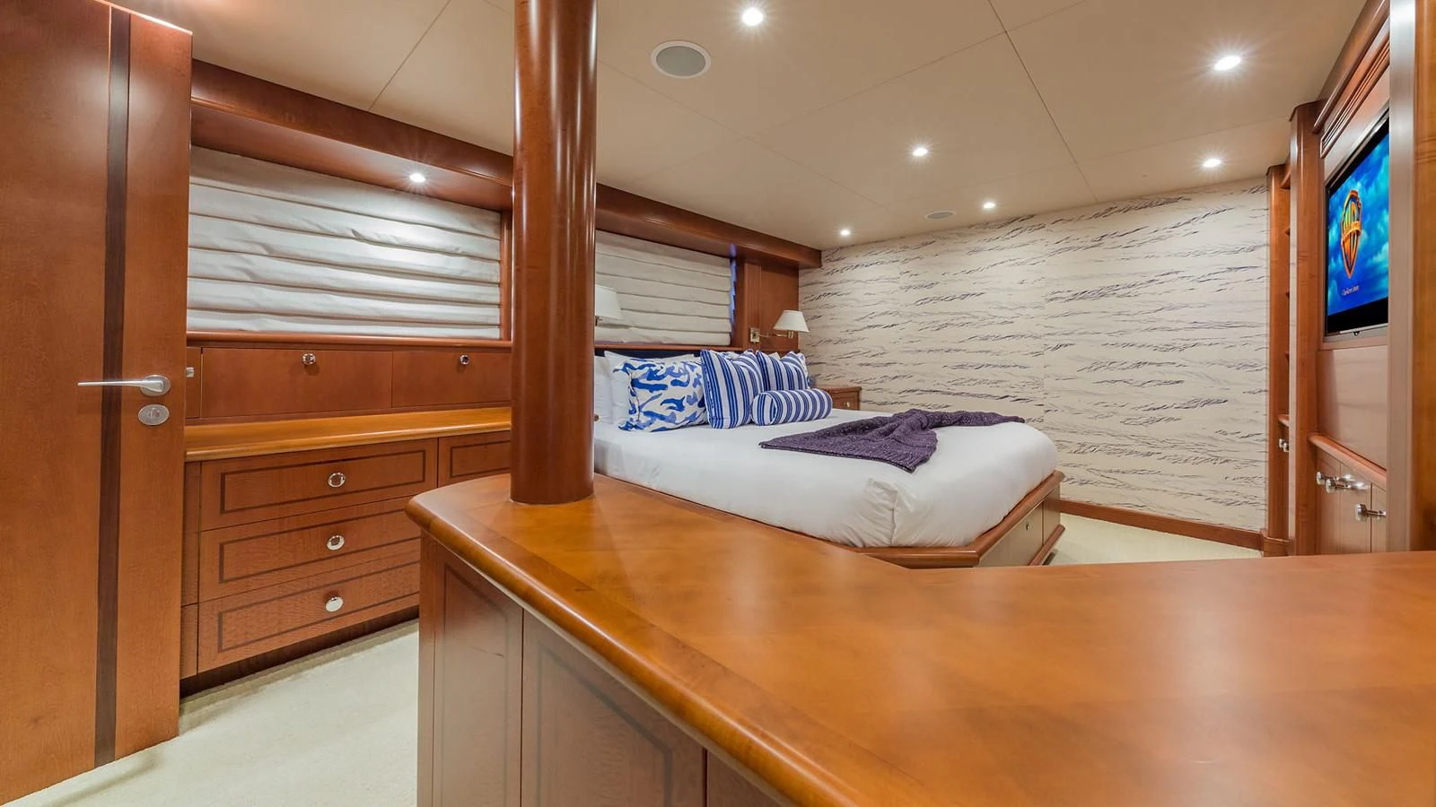 a bedroom with a bed and a tv aboard AT LAST Yacht for Charter