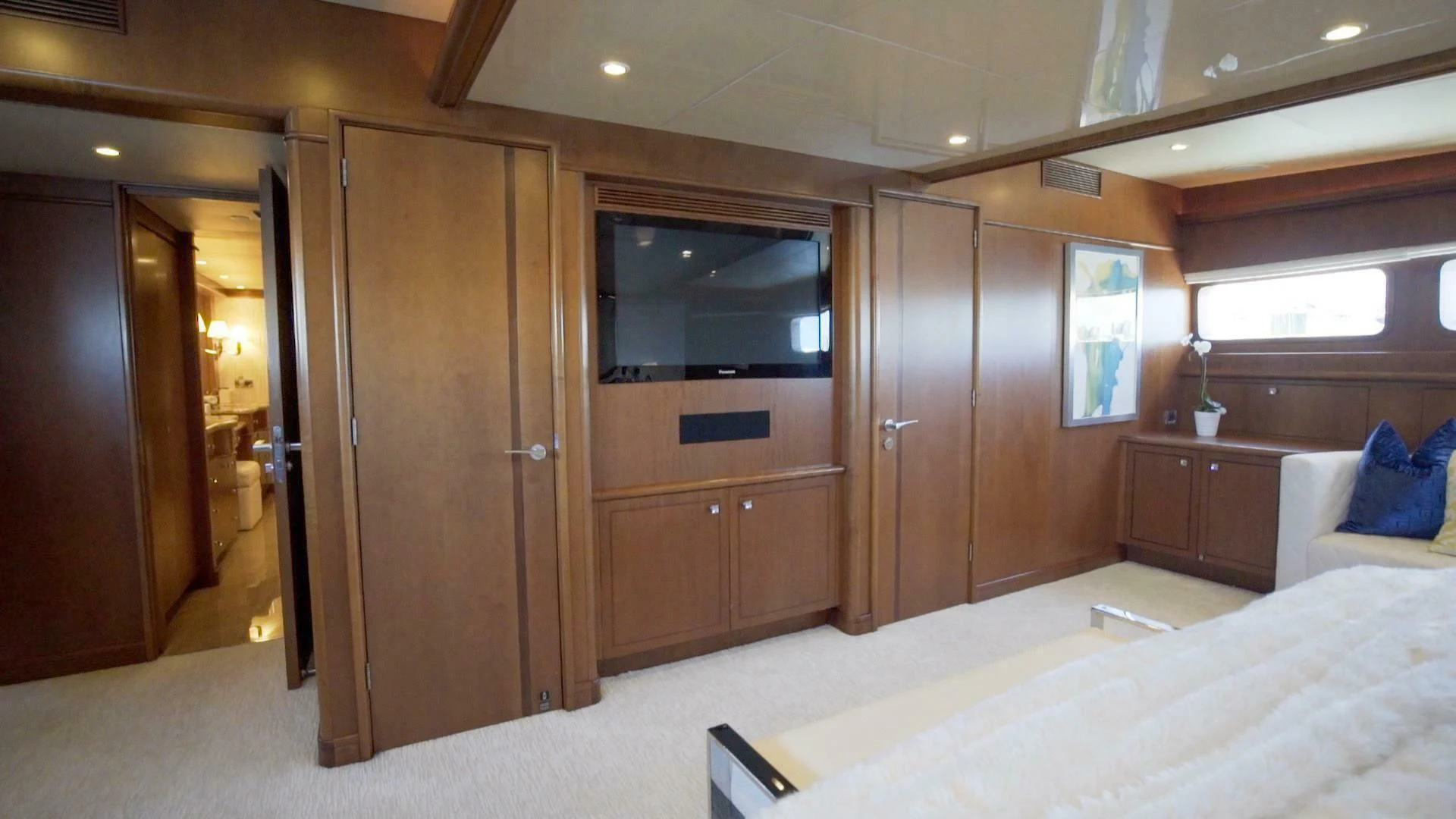 a hotel room with a bed and a television aboard AT LAST Yacht for Charter