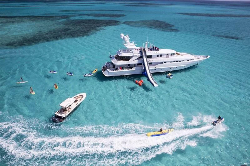 a group of people on surfboards in the ocean aboard AT LAST Yacht for Charter