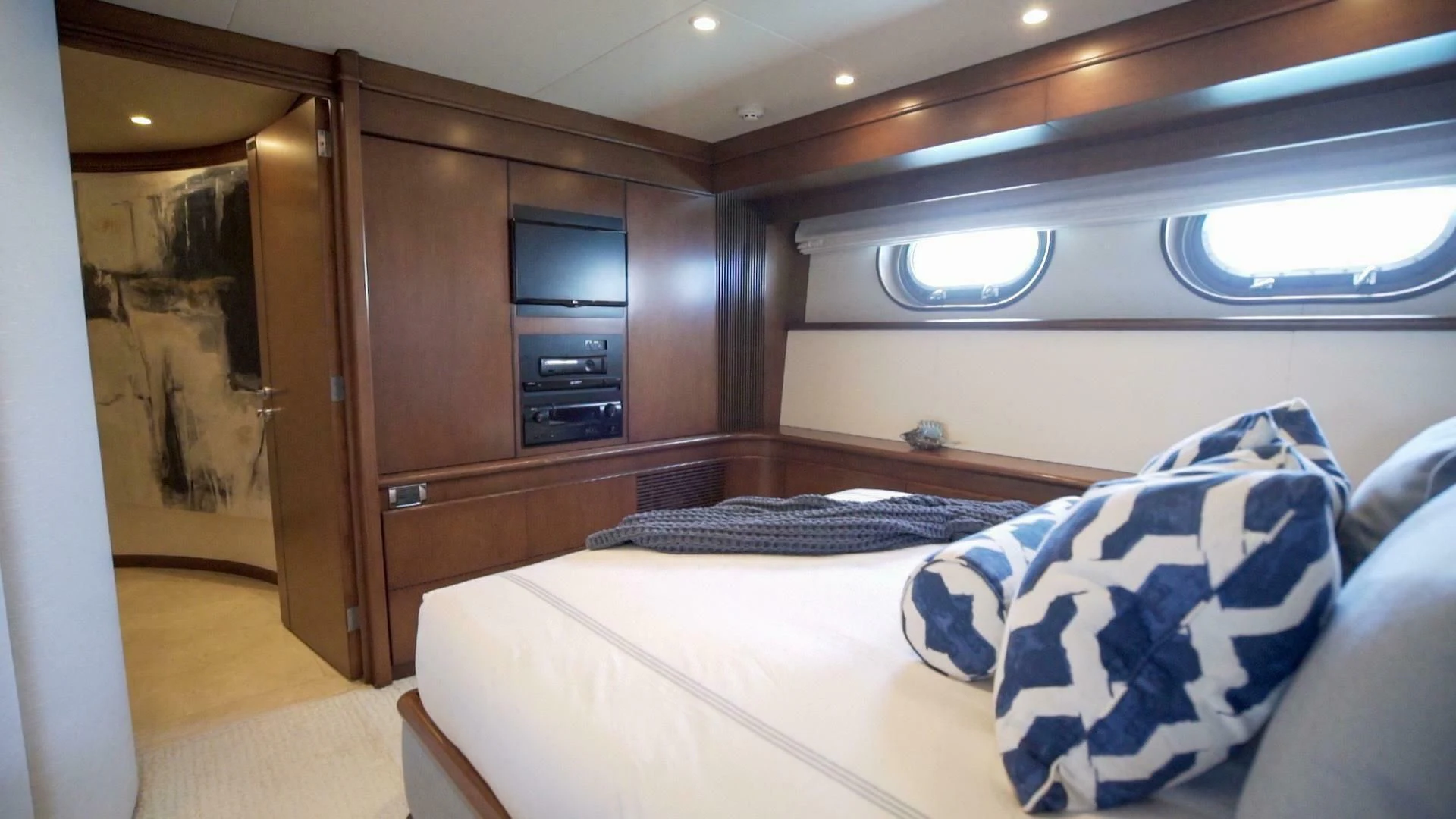 a room with a bed and a cabinet aboard AT LAST Yacht for Charter