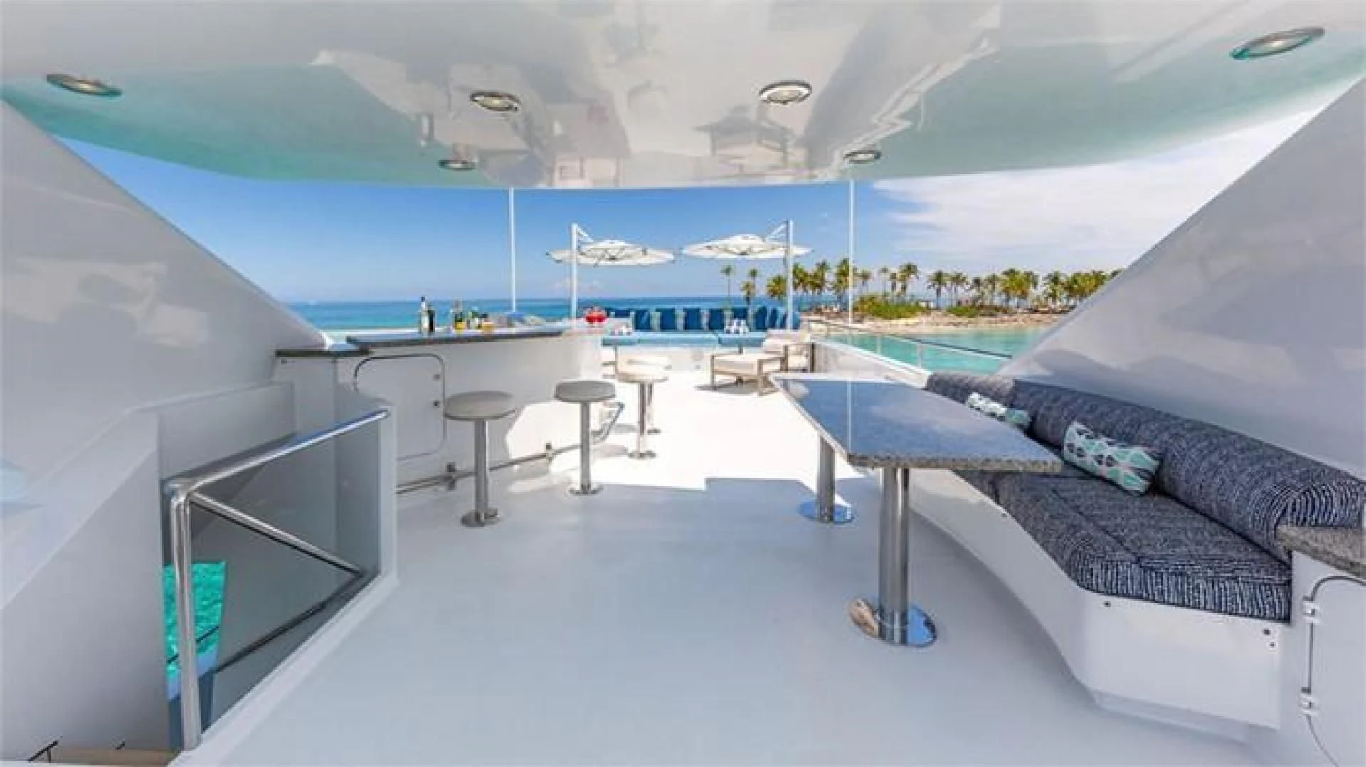a room with a bed and a table and chairs aboard AT LAST Yacht for Charter