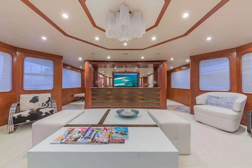 a living room with a large screen aboard AT LAST Yacht for Charter