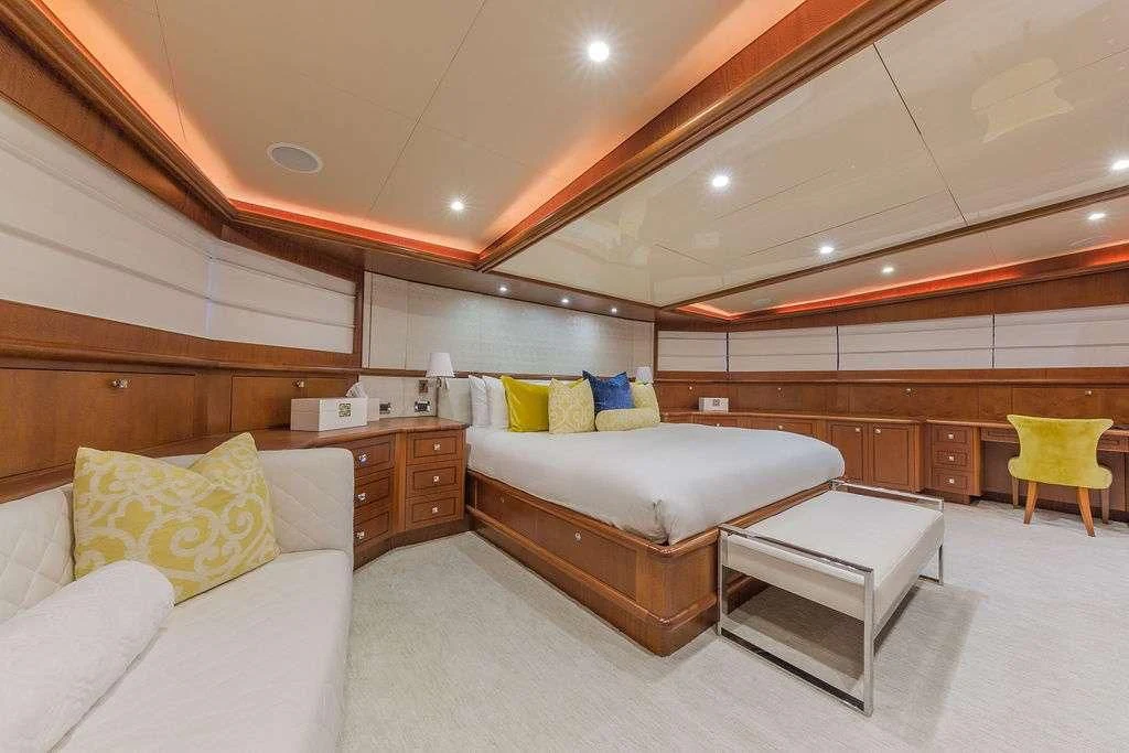 a bedroom with a bed and a couch aboard AT LAST Yacht for Charter