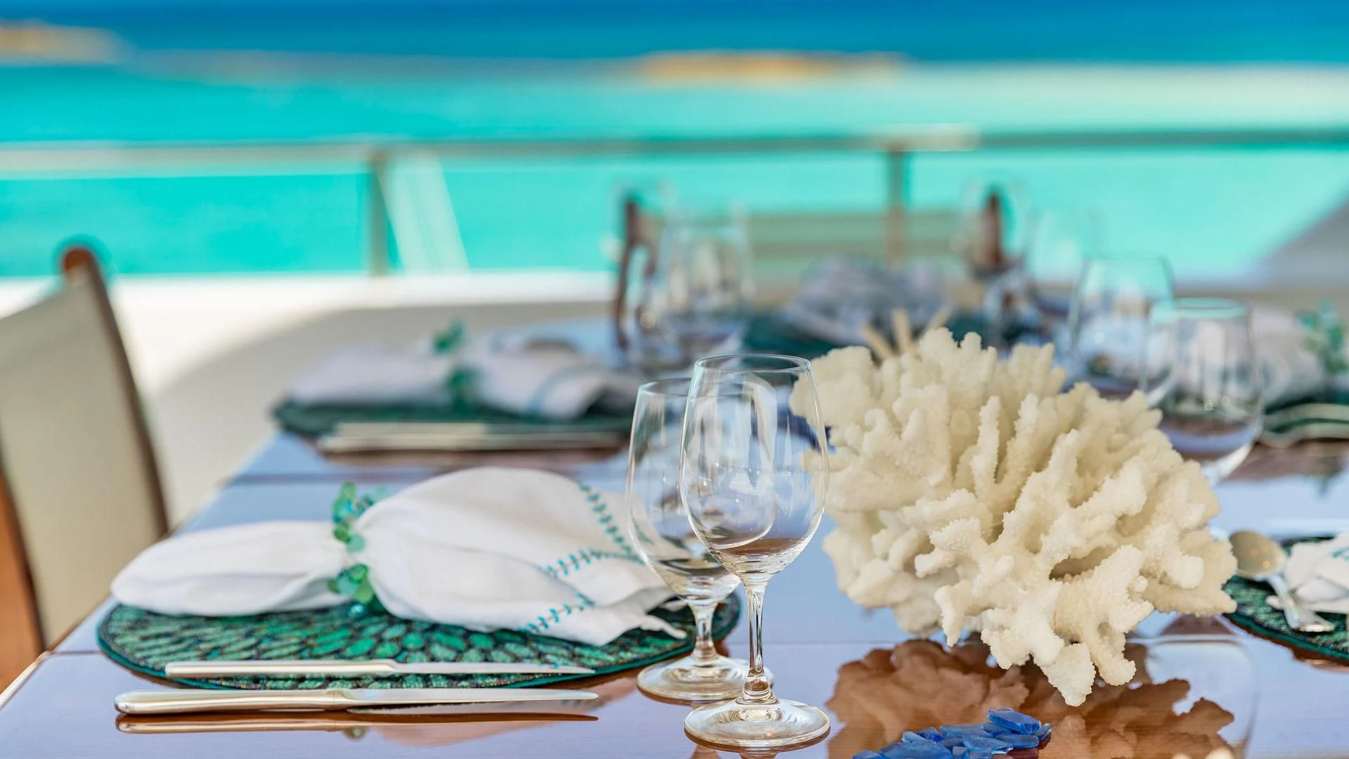 a table with plates and glasses aboard AT LAST Yacht for Charter