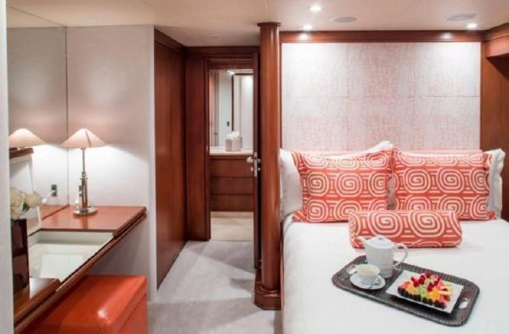 a hotel room with a bed and coffee table aboard AT LAST Yacht for Charter
