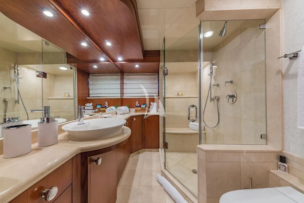 a bathroom with a shower and sink aboard AT LAST Yacht for Charter