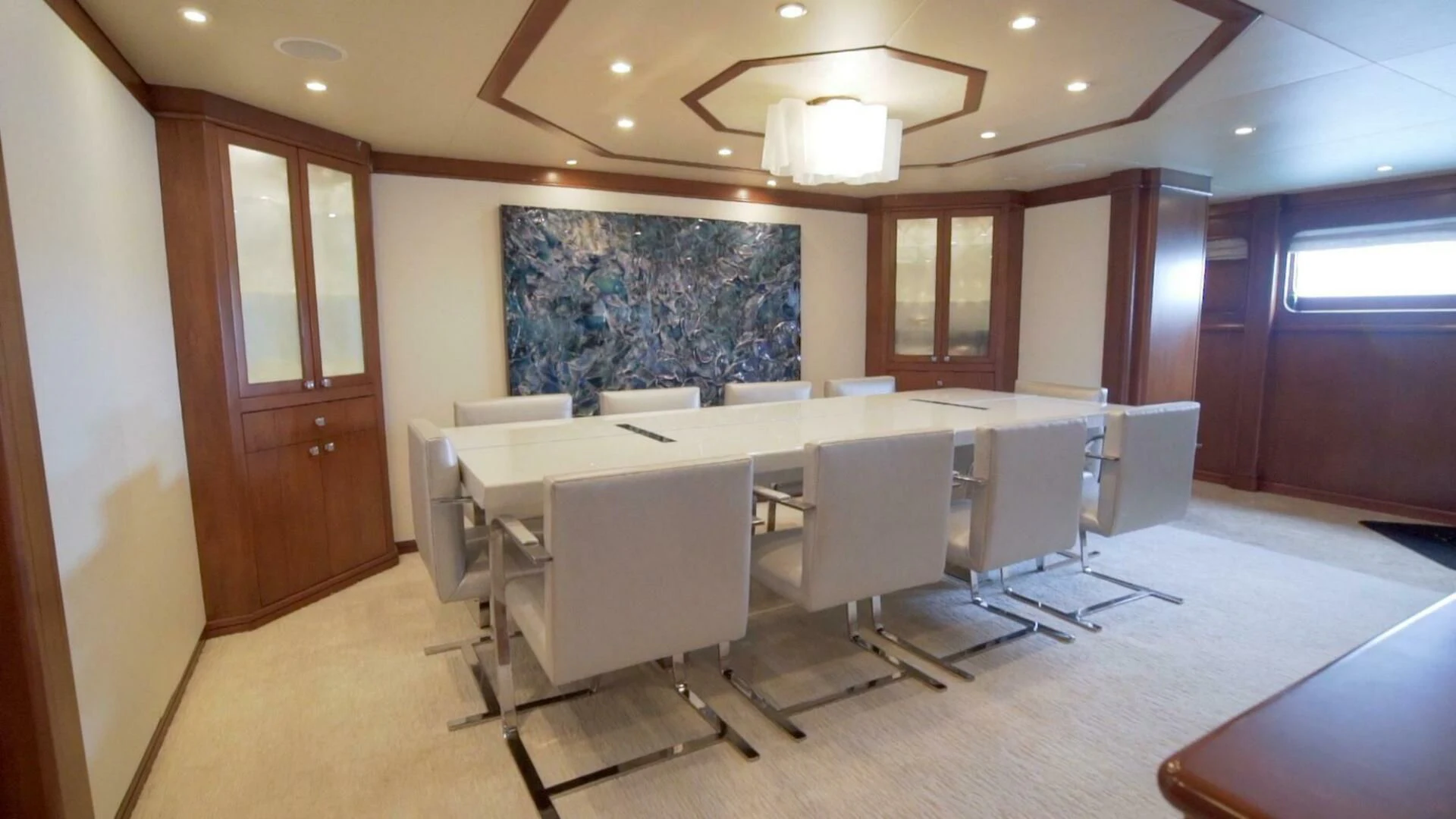 a conference room with tables and chairs aboard AT LAST Yacht for Charter