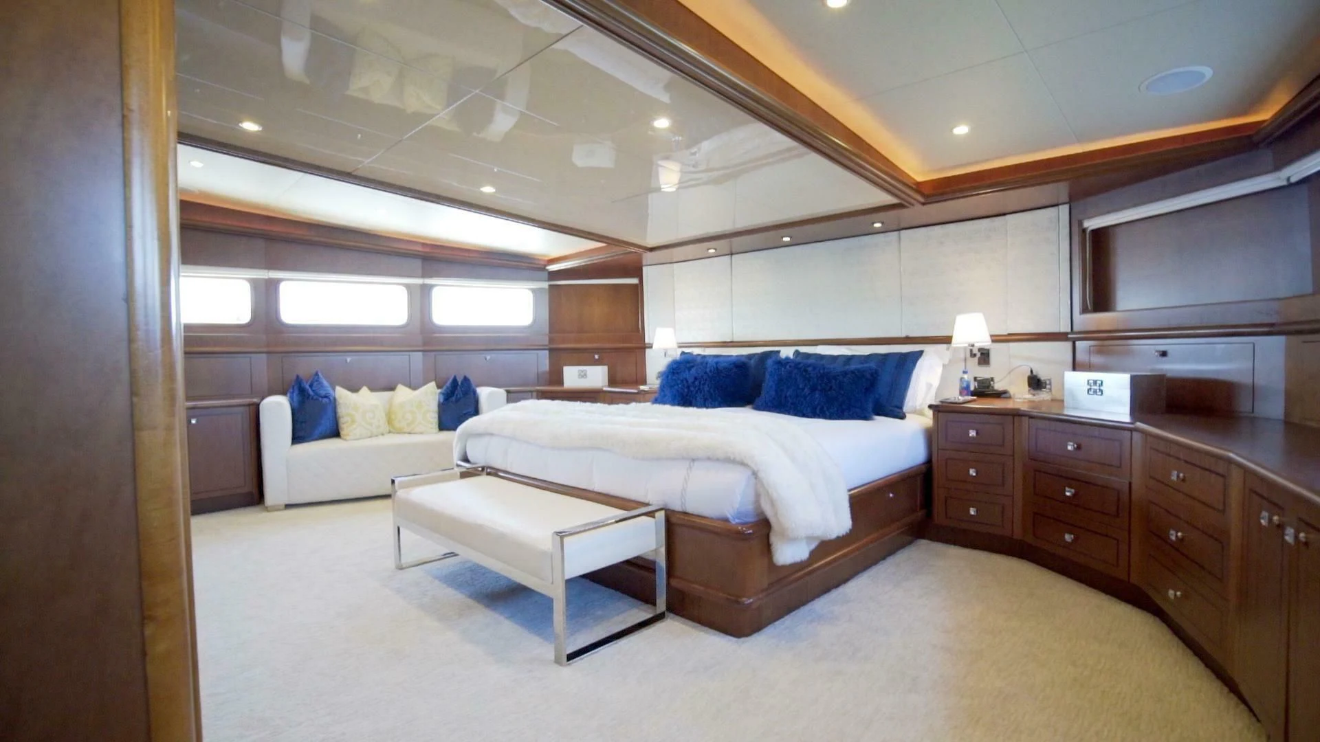 a room with a bed and a couch aboard AT LAST Yacht for Charter
