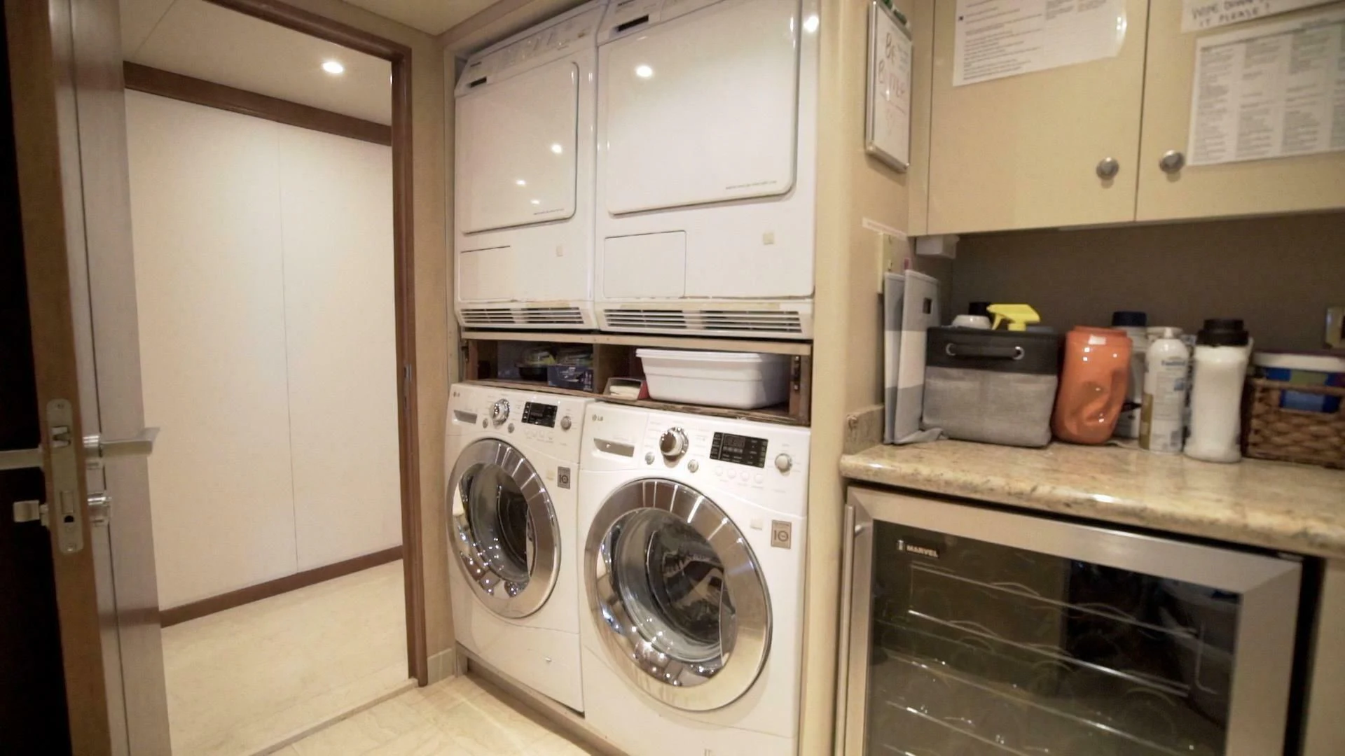 a kitchen with white cabinets aboard AT LAST Yacht for Charter