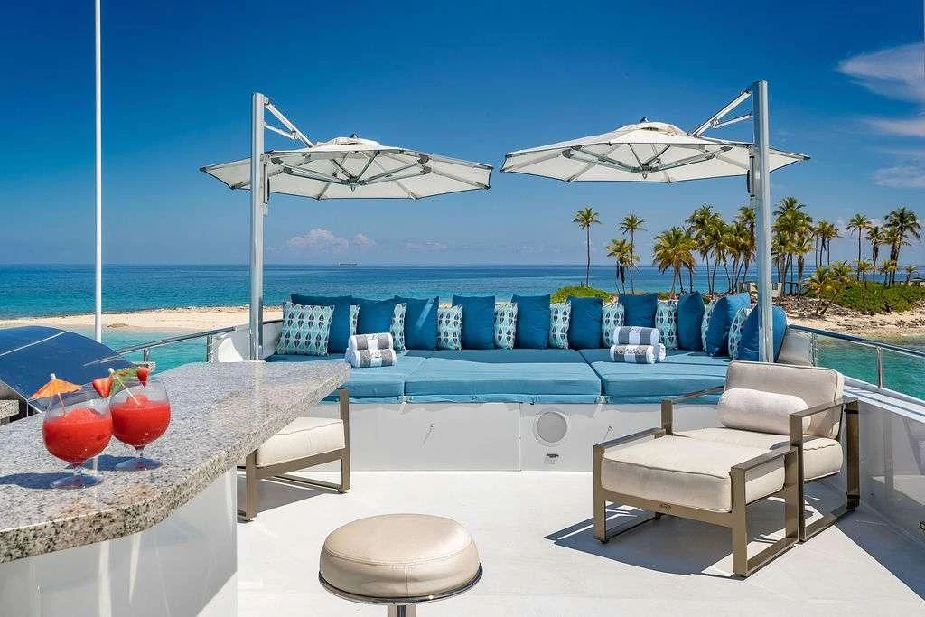 a pool with chairs and umbrellas aboard AT LAST Yacht for Charter