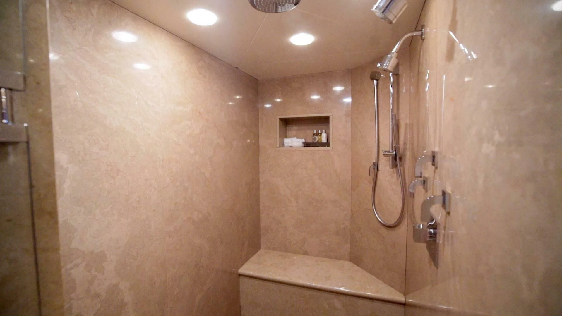 a bathroom with a shower and a mirror aboard AT LAST Yacht for Charter
