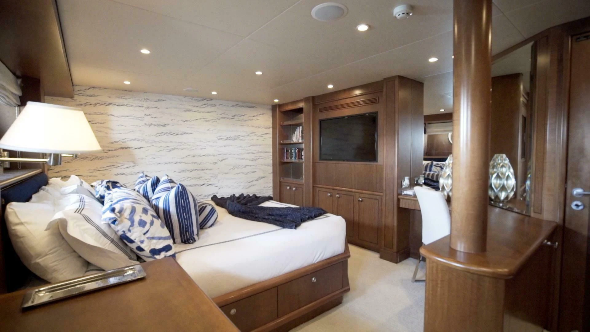 a bedroom with a bed and a desk aboard AT LAST Yacht for Charter