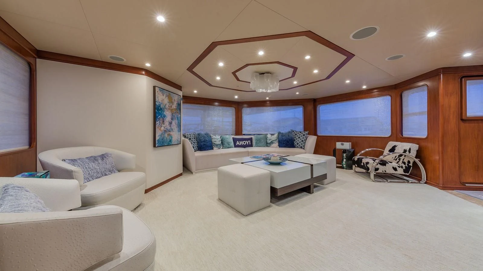 a living room with a large white couch and a large window aboard AT LAST Yacht for Charter