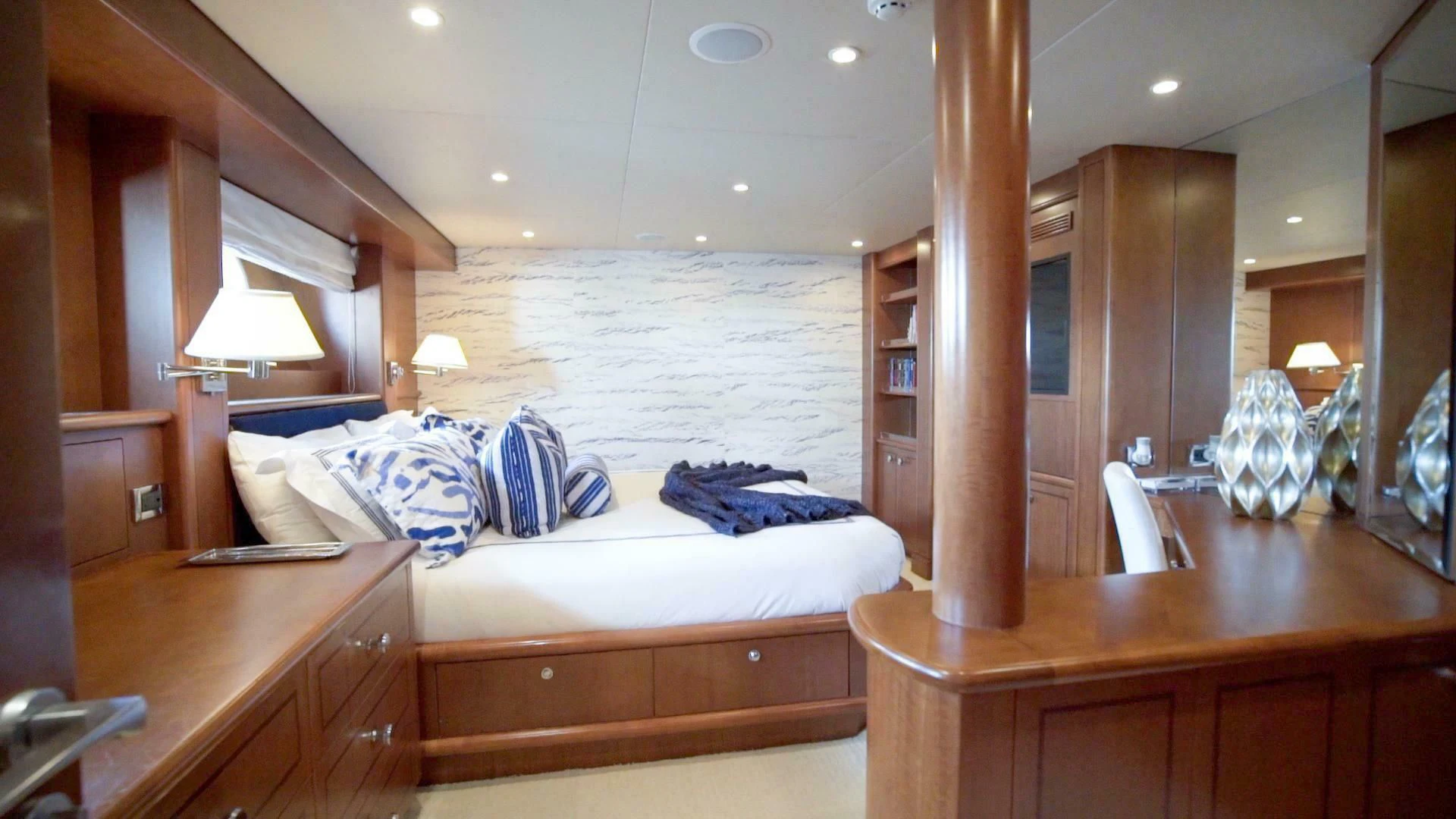 a bedroom with a bed and desk aboard AT LAST Yacht for Charter