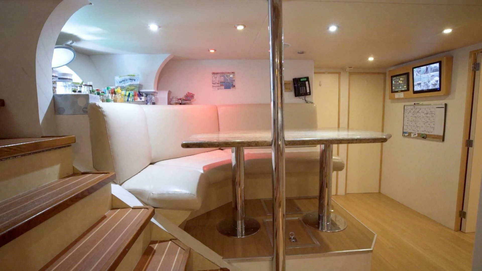 a room with a table and a couch aboard AT LAST Yacht for Charter