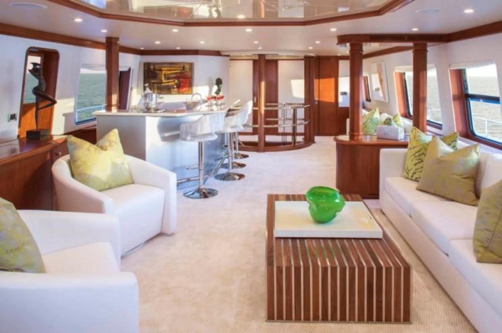 a living room with a table and couches aboard AT LAST Yacht for Charter