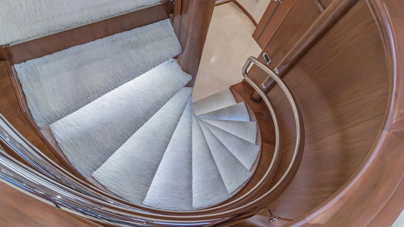 a staircase with a white rug aboard AT LAST Yacht for Charter