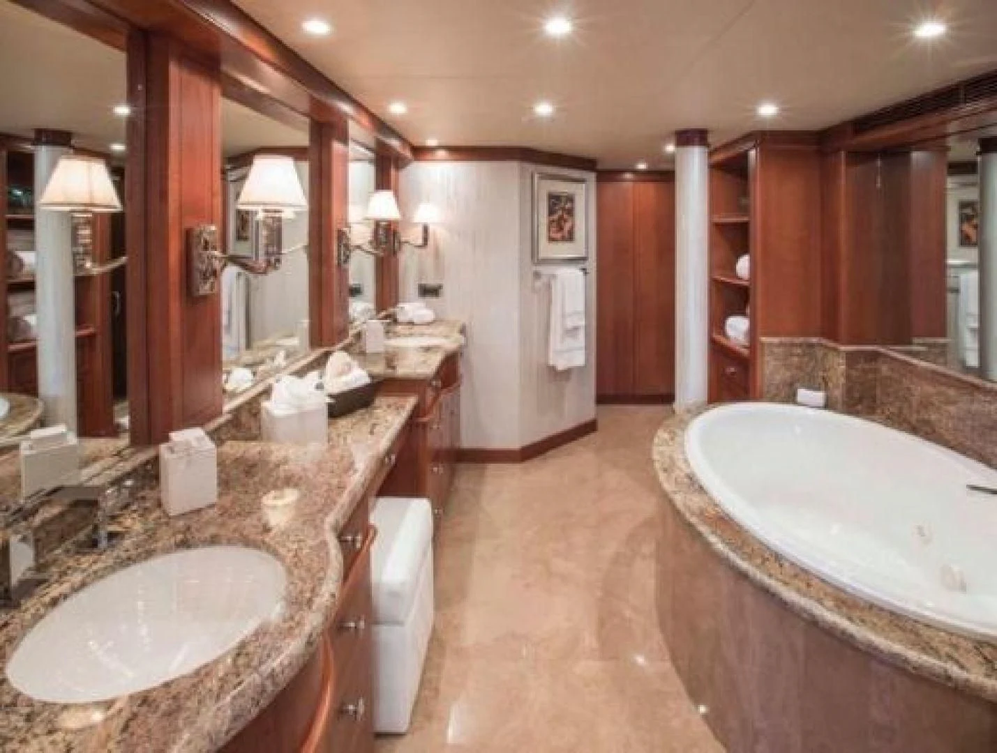 a bathroom with a large bathtub and sinks aboard AT LAST Yacht for Charter