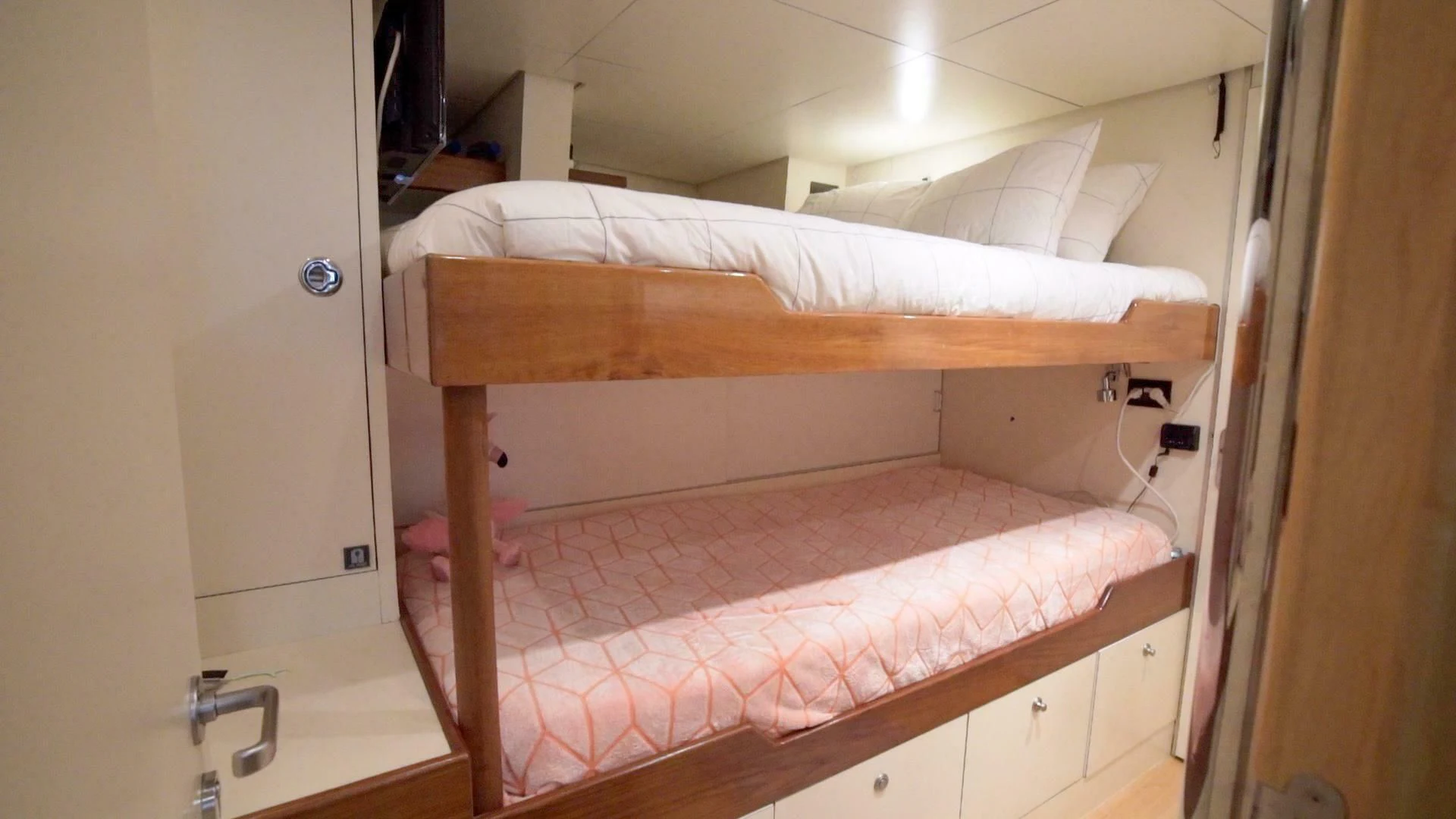 a bed with a red sheet aboard AT LAST Yacht for Charter