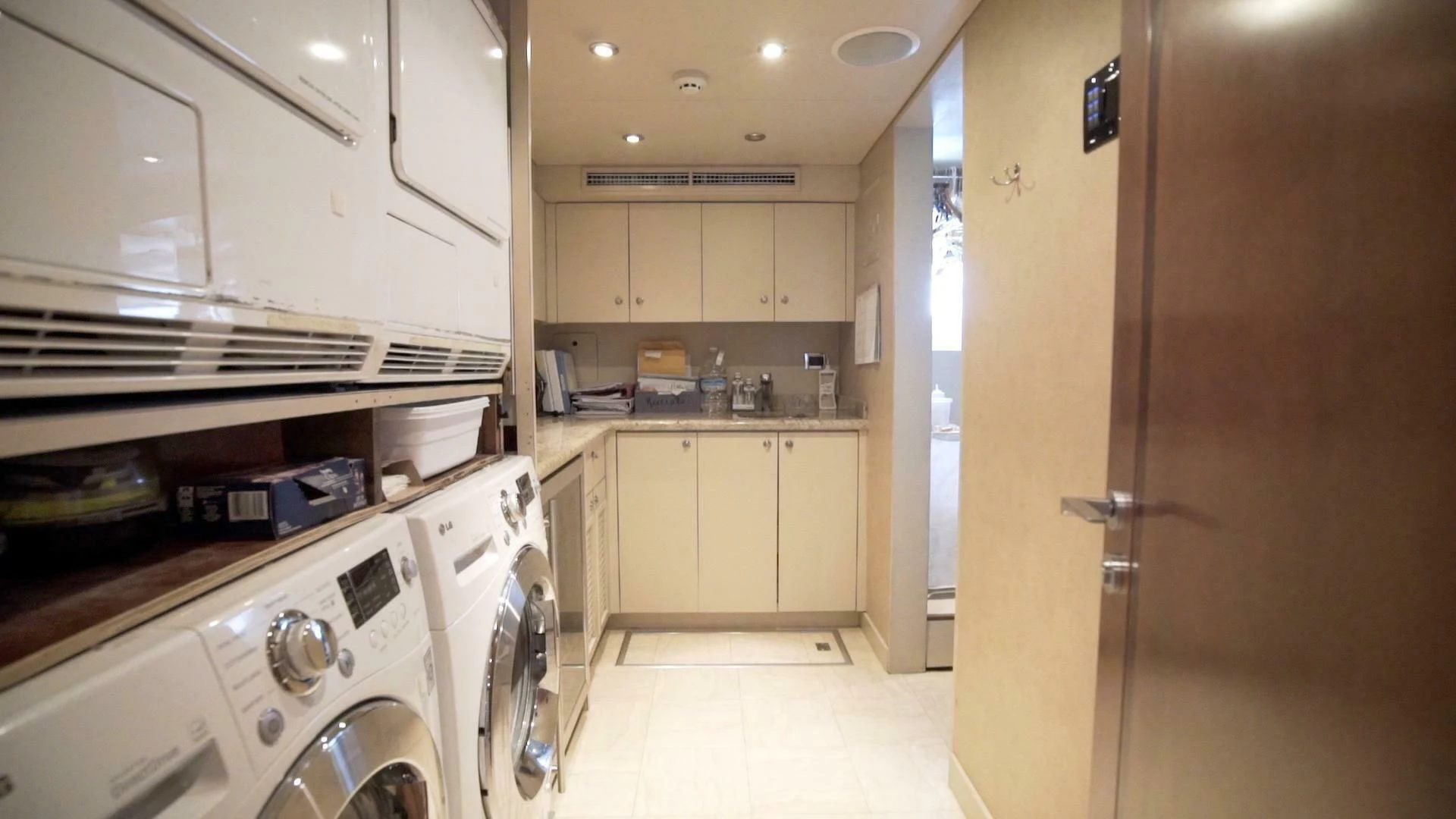 a kitchen with white cabinets aboard AT LAST Yacht for Charter