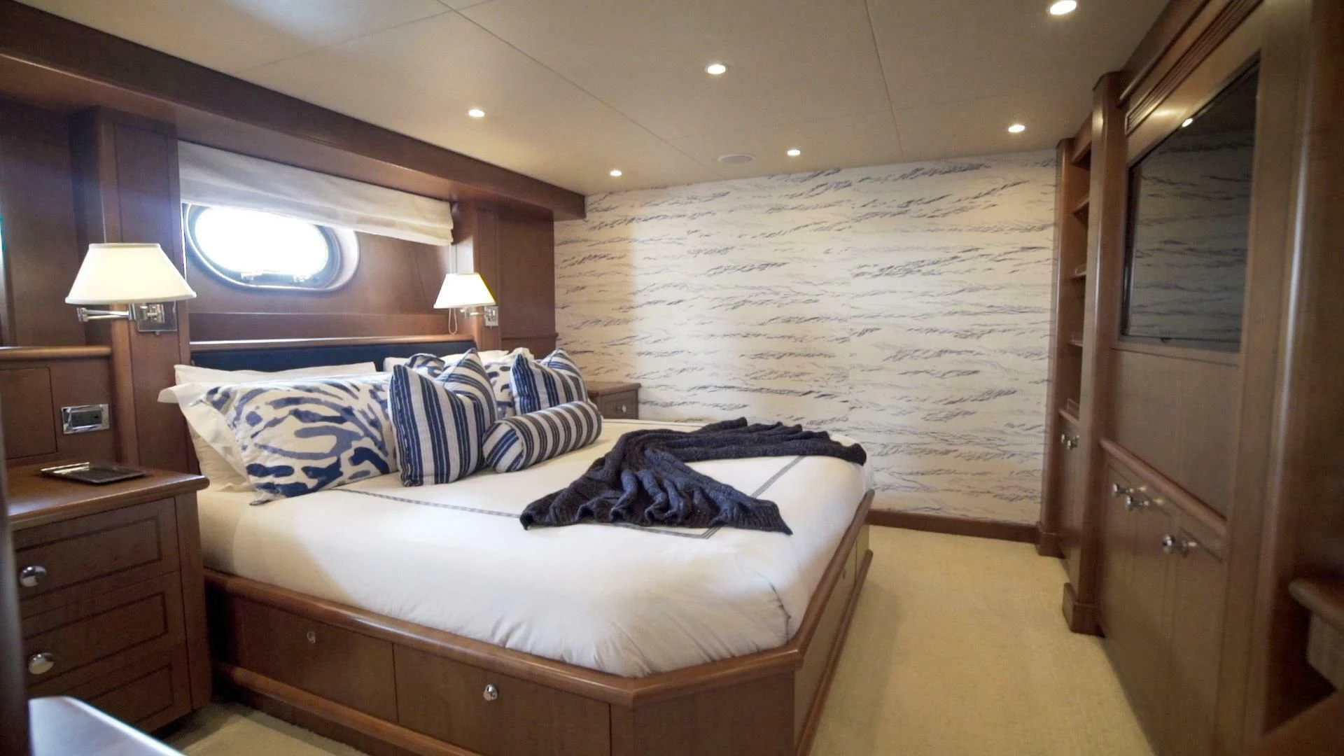 a bedroom with a bed and a desk aboard AT LAST Yacht for Charter