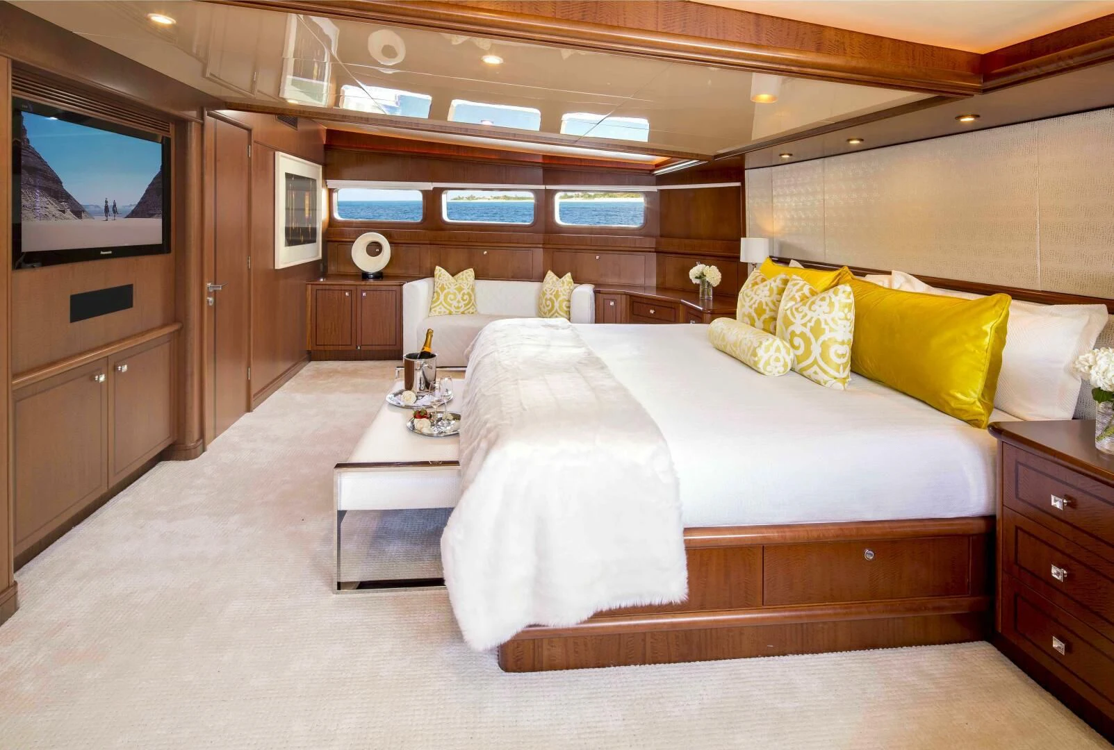 a room with a bed and a television aboard AT LAST Yacht for Charter