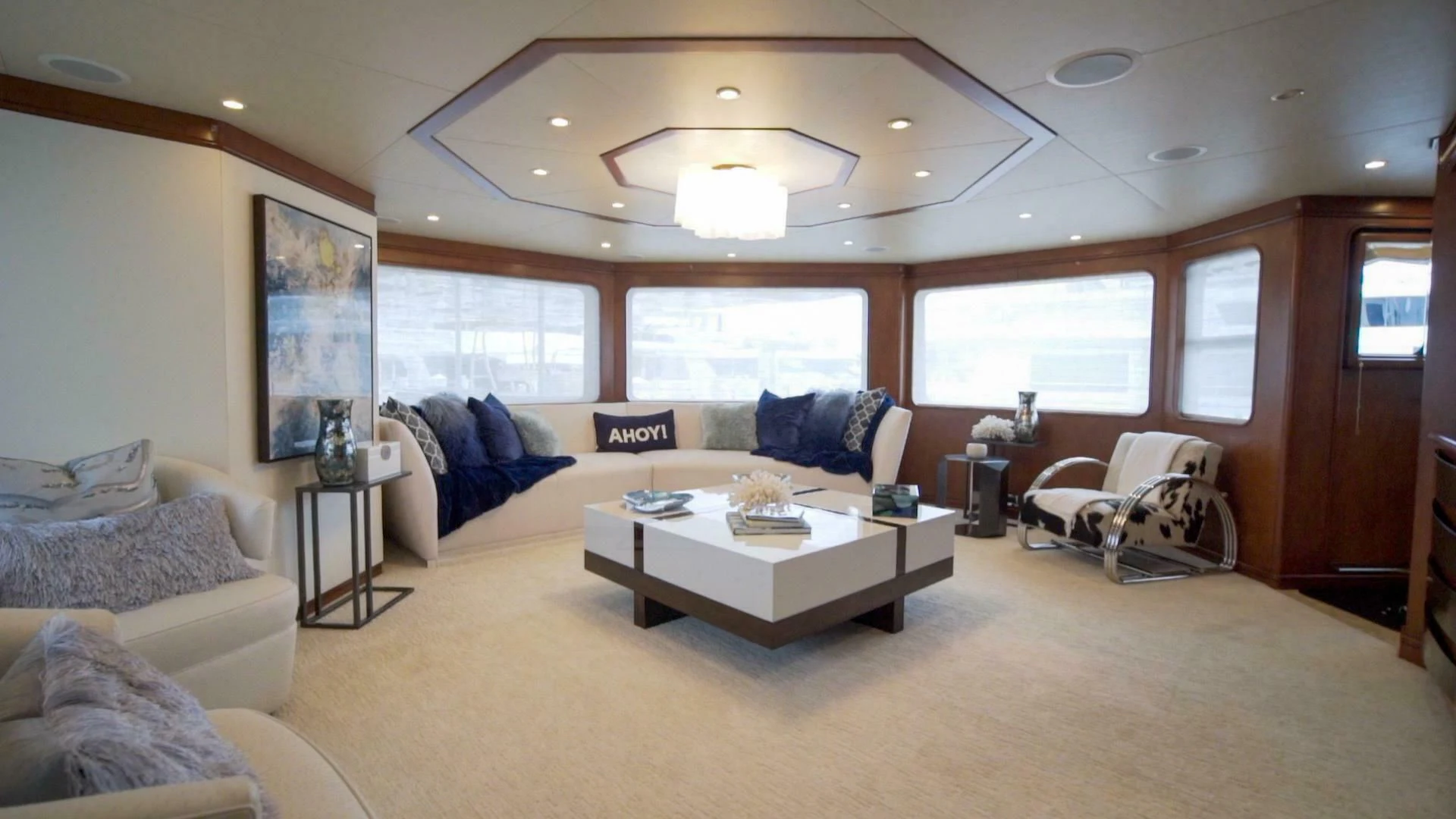 a living room with a couch and a coffee table aboard AT LAST Yacht for Charter