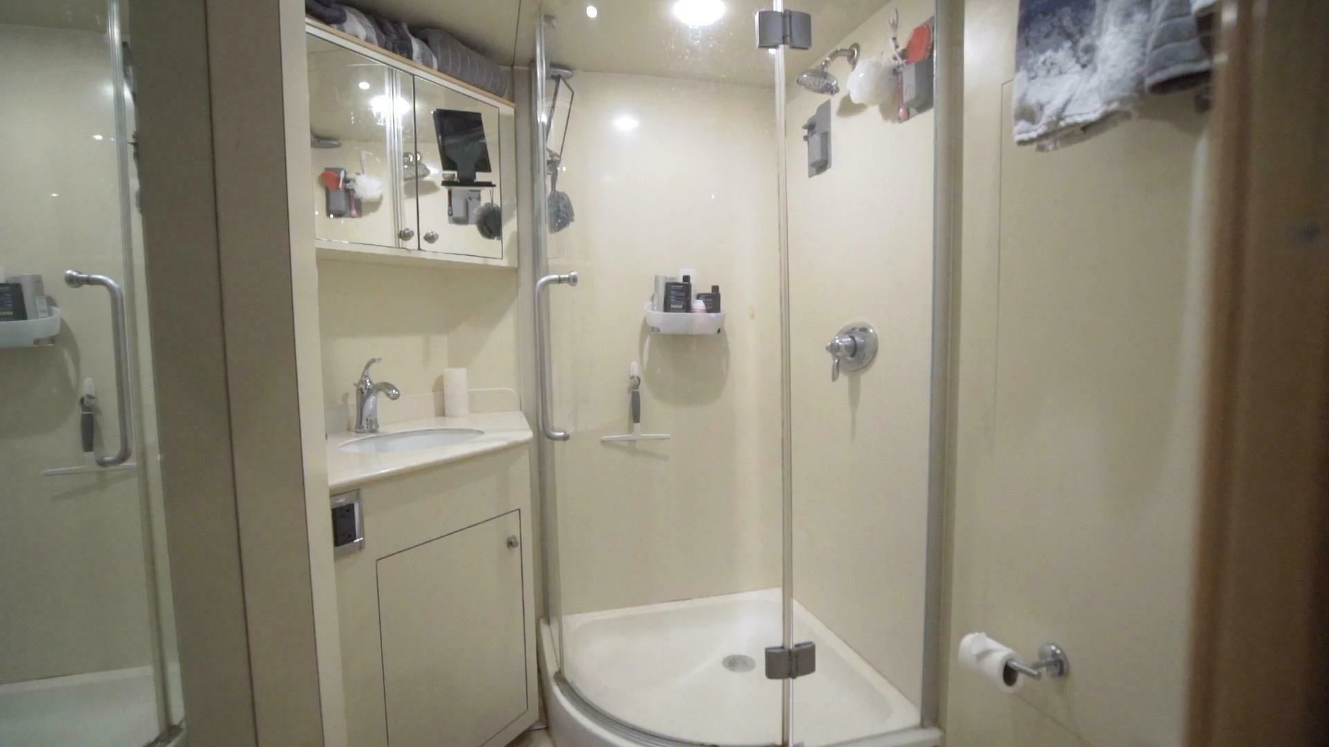 a bathroom with a shower and sink aboard AT LAST Yacht for Charter