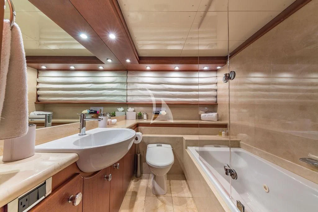 a bathroom with a tub sink and toilet aboard AT LAST Yacht for Charter