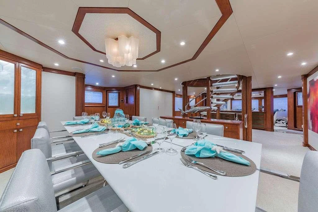 a large kitchen with a dining table aboard AT LAST Yacht for Charter