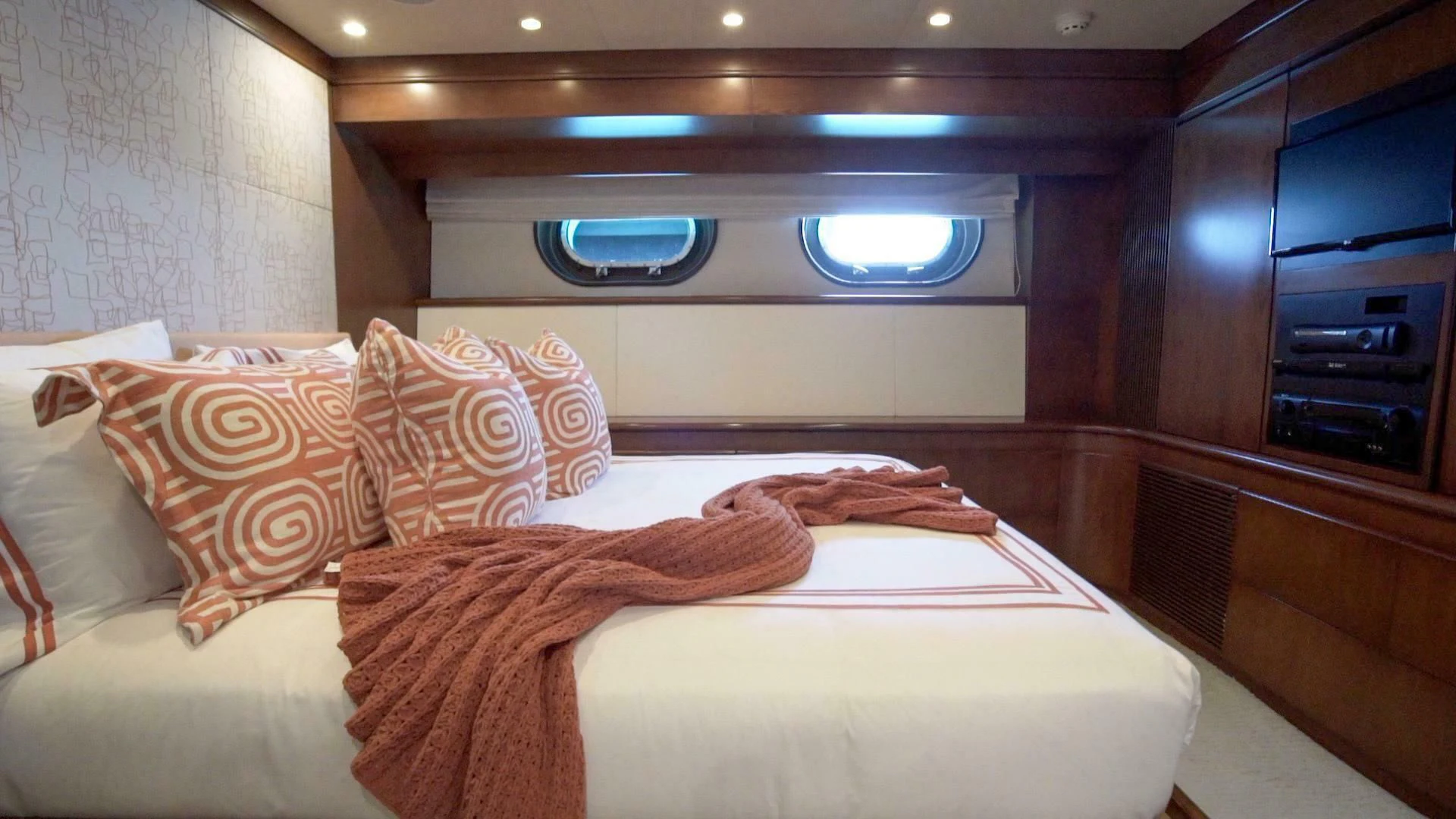 a bed with pillows aboard AT LAST Yacht for Charter