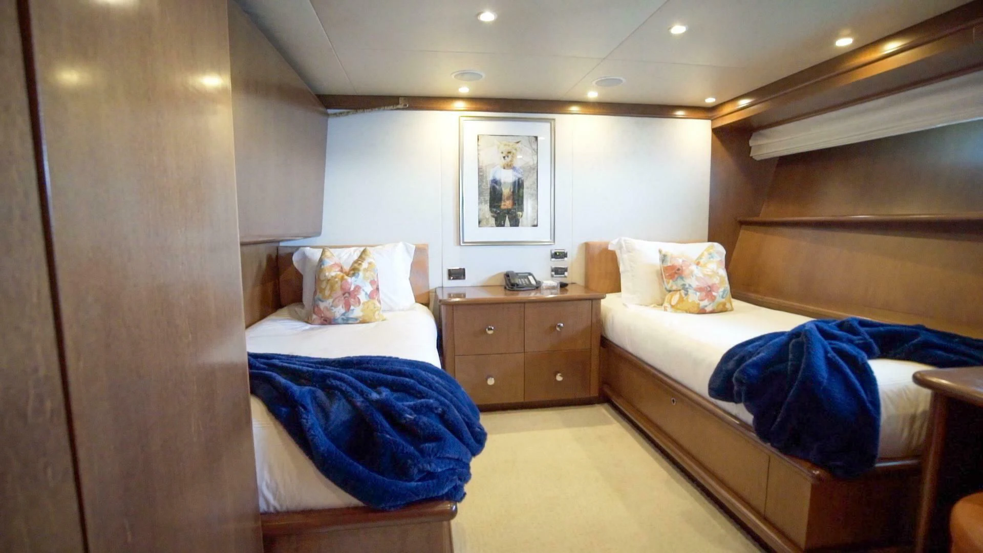 a room with beds and a dresser aboard AT LAST Yacht for Charter
