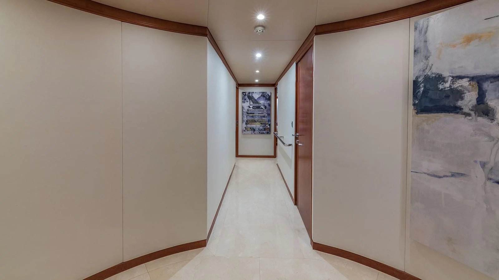 a hallway with a door and a painting on the wall aboard AT LAST Yacht for Charter