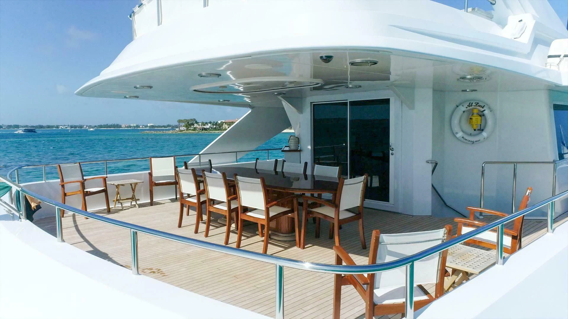 a deck with chairs and tables on it aboard AT LAST Yacht for Charter