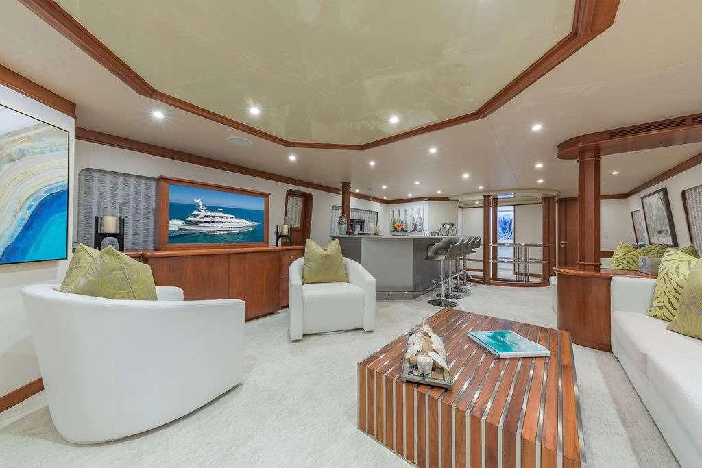 a living room with a large screen aboard AT LAST Yacht for Charter