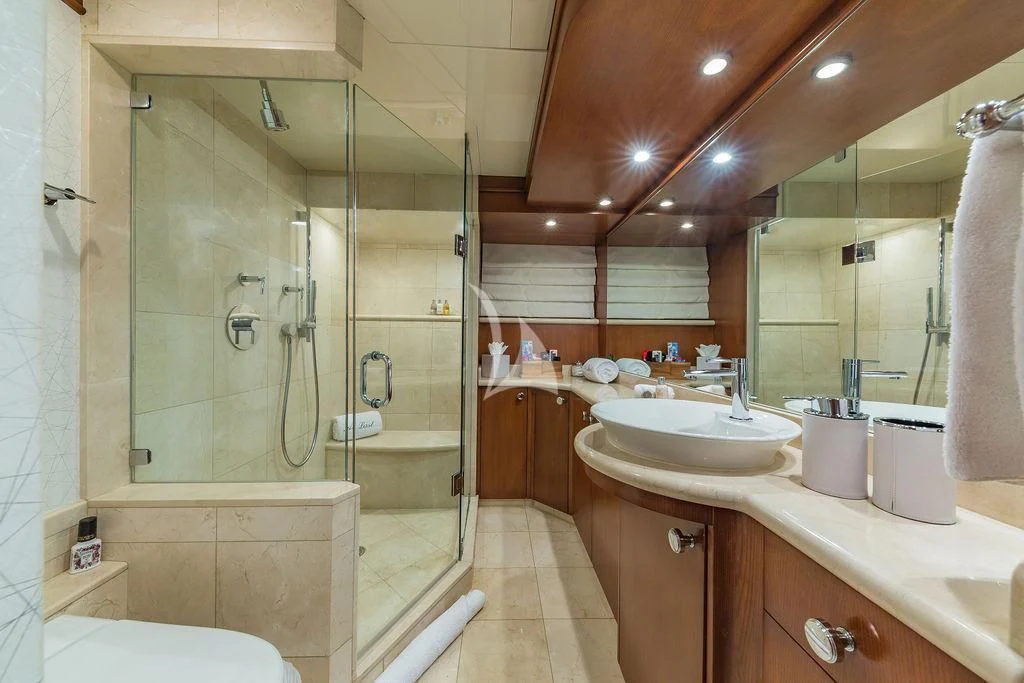 a bathroom with a glass shower aboard AT LAST Yacht for Charter