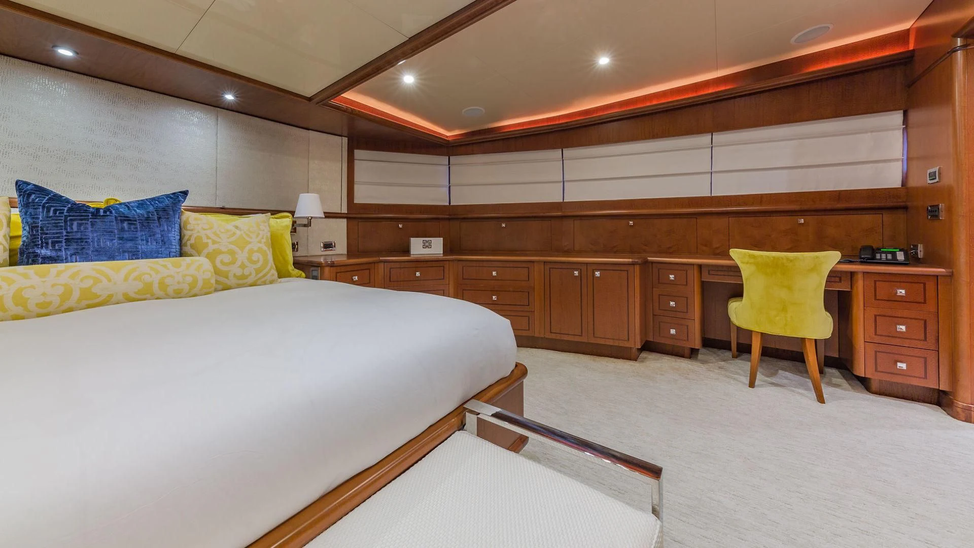 a room with a bed and a chair aboard AT LAST Yacht for Charter