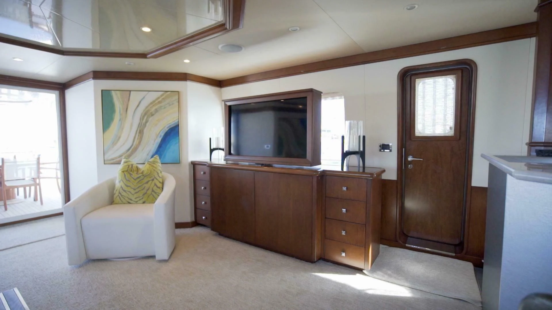 a living room with a tv and furniture aboard AT LAST Yacht for Charter