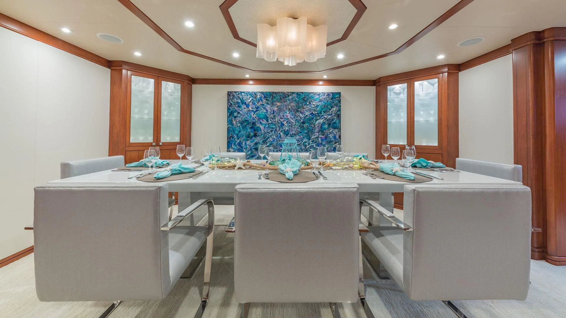 a large white office with a large table and chairs aboard AT LAST Yacht for Charter