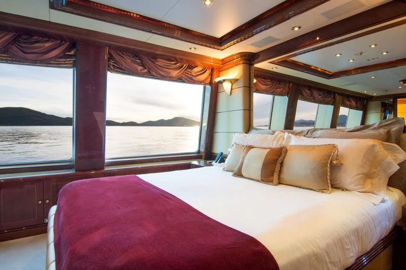 a bed with a large window aboard ZEFZAF Yacht for Sale