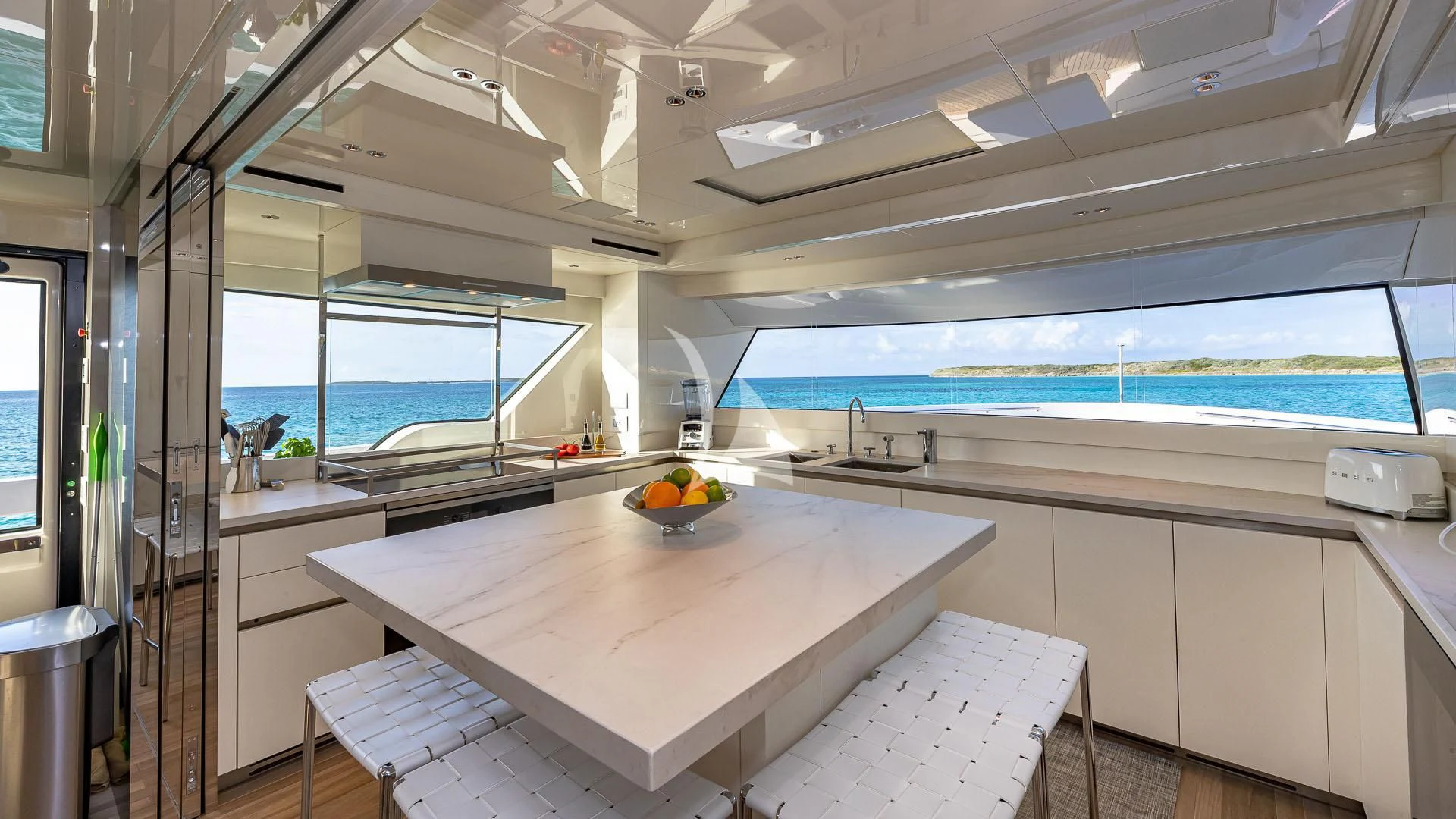 a kitchen with a table and a bowl of fruit aboard NO MATTER WHAT Yacht for Charter