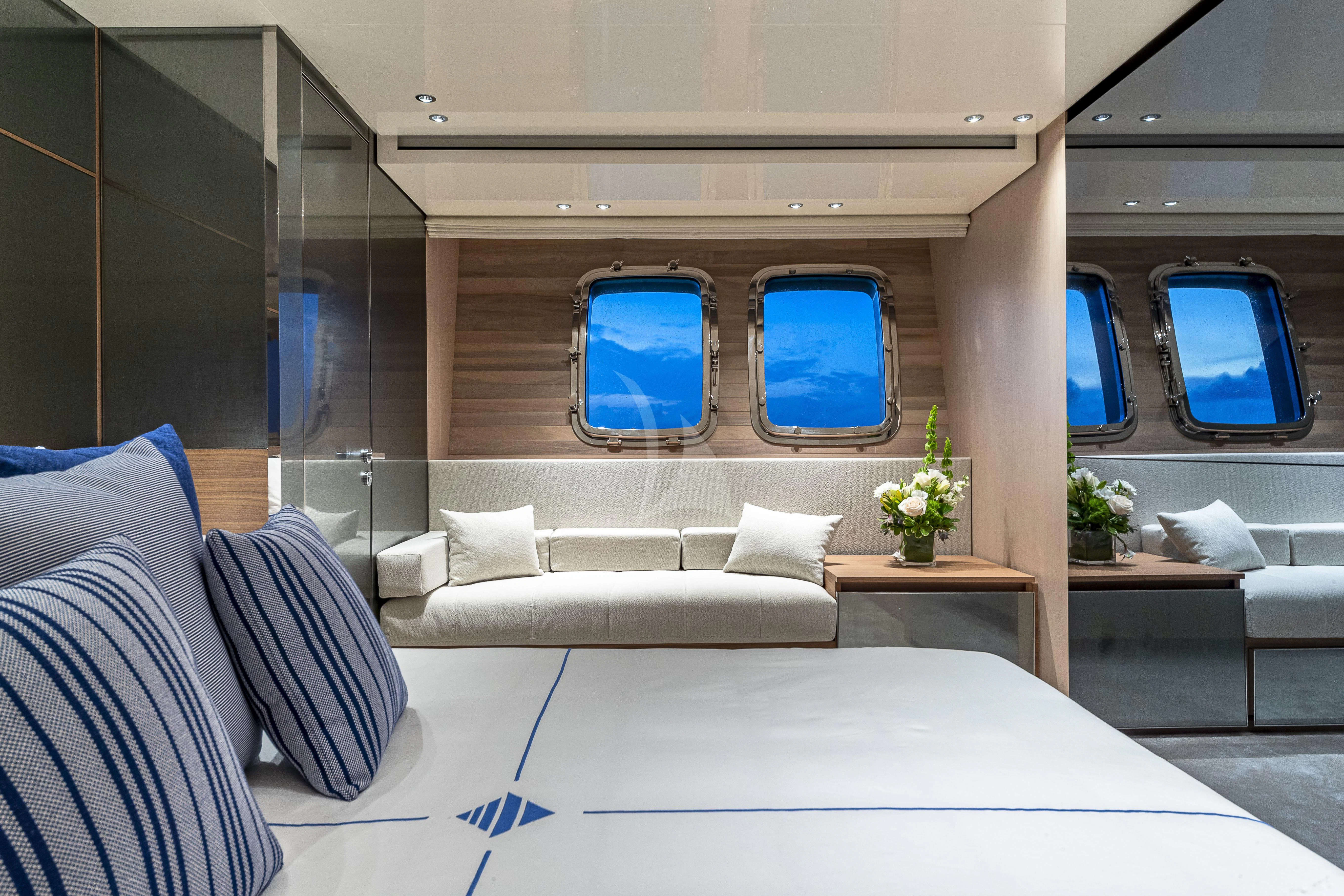 a room with a bed and a table aboard NO MATTER WHAT Yacht for Charter